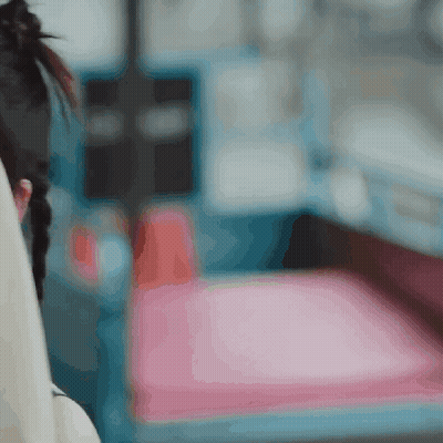 A Blurry Picture Of A Woman Sitting On A Chair GIF