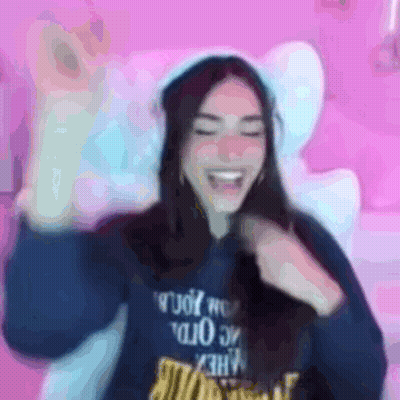 A Blurry Picture Of A Woman Wearing A Blue Sweatshirt With The Word Rude On It GIF