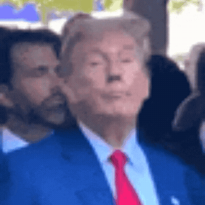 A Blurry Picture Of Donald Trump Wearing A Suit And Tie GIF