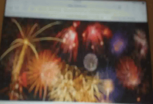 A Blurry Picture Of Fireworks Is Displayed On A Screen GIF