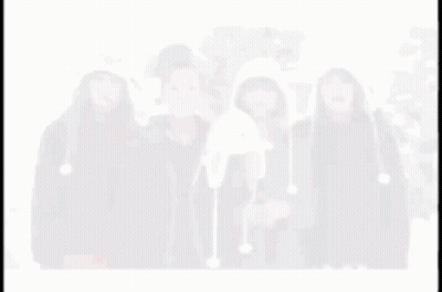 A Blurry Picture Of Four Women Wearing Hats Including One That Looks Like A Penguin GIF