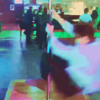 A Blurry Picture Of People Sitting At Tables In A Bar GIF