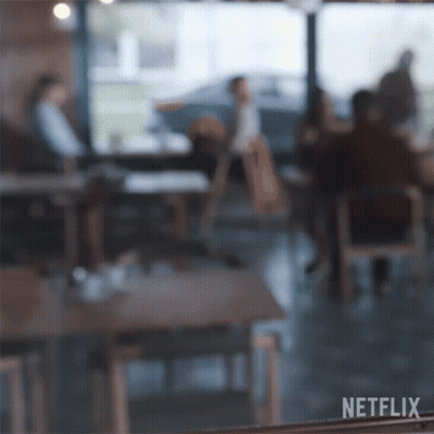 A Blurry Picture Of People Sitting At Tables In A Restaurant With Netflix Written On The Bottom Right GIF