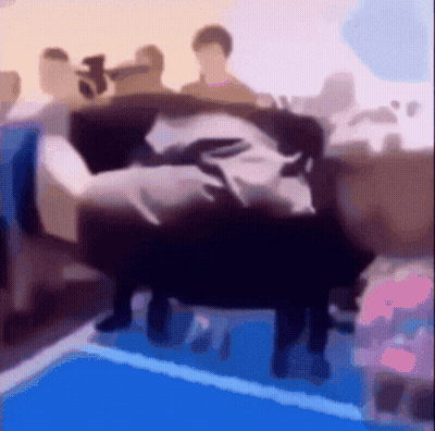 A Blurry Picture Of People Sitting On A Couch In A Room GIF