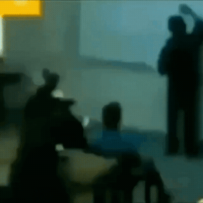 A Blurry Picture Of People Standing In Front Of A Wall GIF