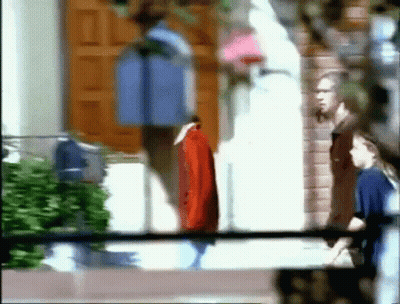 A Blurry Picture Of People Standing Outside A Building GIF