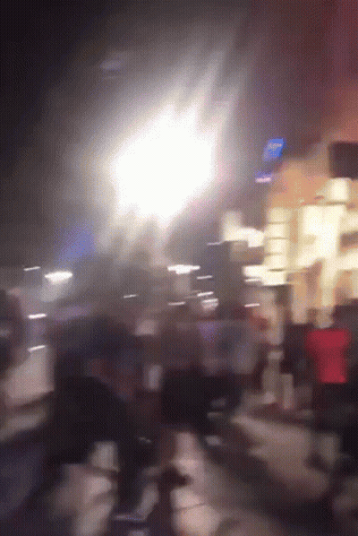 A Blurry Picture Of People Walking Down A Street With A Sign That Says ' Subway ' On It GIF