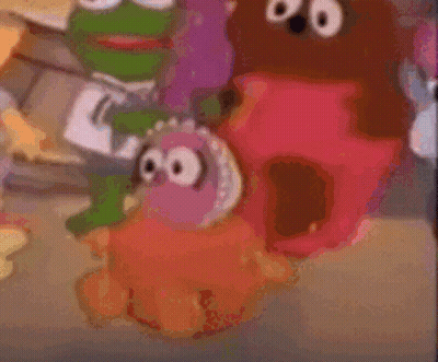 A Blurry Picture Of Sesame Street Characters Including A Frog GIF