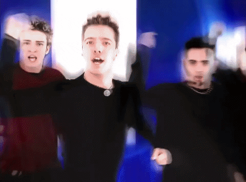 A Blurry Picture Of Three Men Dancing With Their Hands In The Air GIF