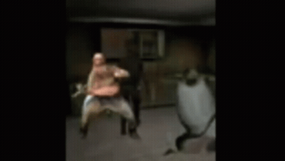 A Blurry Picture Of Three People Dancing In A Room . GIF