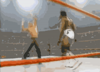 A Blurry Picture Of Two Men In A Boxing Ring With A Red Rope GIF