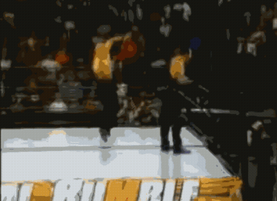 A Blurry Picture Of Two Men In A Boxing Ring With One Wearing A Pair Of White Underwear GIF