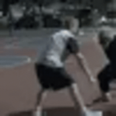 A Blurry Picture Of Two Men Playing Soccer On A Track . GIF
