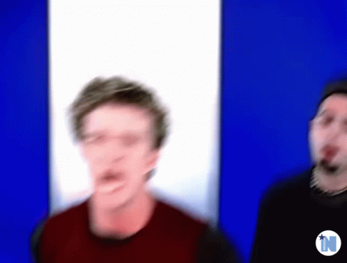 A Blurry Picture Of Two Men With The Letter N In The Corner GIF