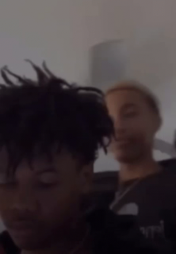 A Blurry Picture Of Two People With The Words " Join The Clique " In The Corner GIF