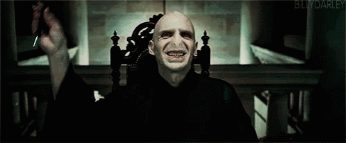 A Blurry Picture Of Voldemort From Harry Potter With A Blue Light Coming Out Of His Eyes GIF
