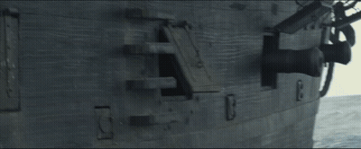 A Boat In The Middle Of A Large Body Of Water With A Blue Sky GIF