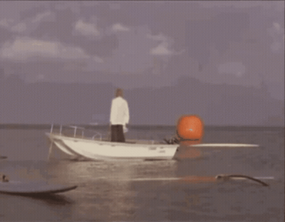 A Boat Is Being Launched Into The Ocean With Smoke Coming From It GIF