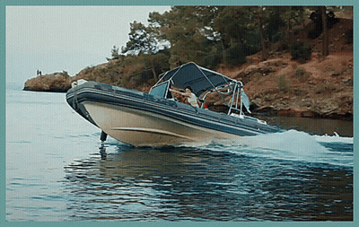 A Boat Is Floating On A Body Of Water Near A Cliff GIF