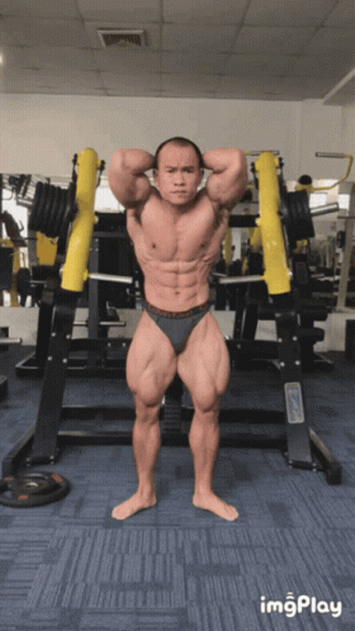 A Bodybuilder Stands In Front Of A Barbell In A Gym With The Word Imgplay Below Him GIF