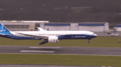 A Boeing 777 Jet Is Taking Off From An Airport Runway GIF