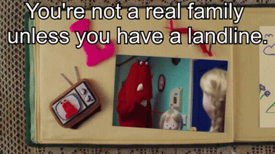 A Book Is Open To A Page That Says You 'Re Not A Real Family Unless You Have A Landline .. GIF