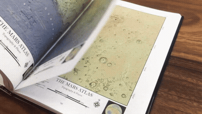 A Book Is Open To A Page Titled " The Mars Atlas " GIF