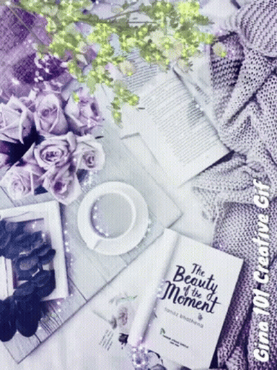 A Book Titled " The Beauty Of The Moment " Sits On A Table GIF
