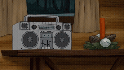 A Boombox Sits On A Wooden Table Next To A Red Candle GIF