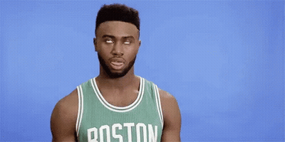 A Boston Celtics Basketball Player Is Making A Funny Face While Wearing A Green Jersey . GIF