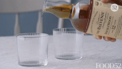 A Bottle Of Balvenie Whiskey Is Being Poured Into A Glass GIF
