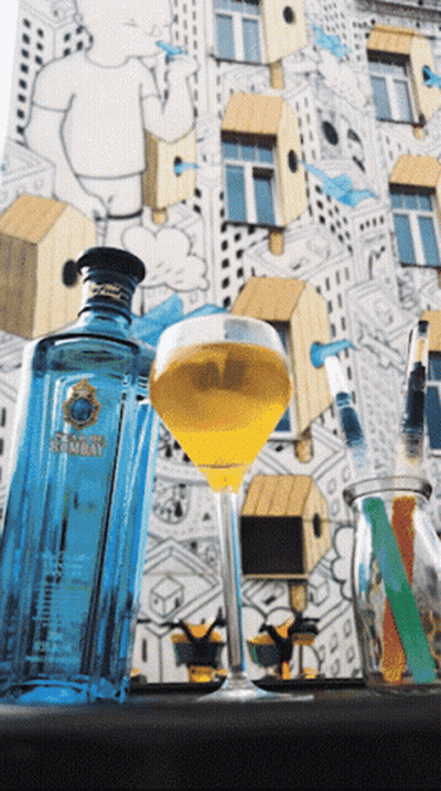 A Bottle Of Bombay Gin Sits Next To A Full Glass GIF