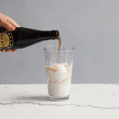 A Bottle Of Boot Beer Is Poured Into A Glass GIF