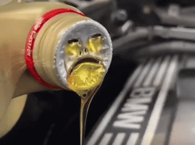 A Bottle Of Castrol Oil Being Poured Into A Bmw Engine GIF