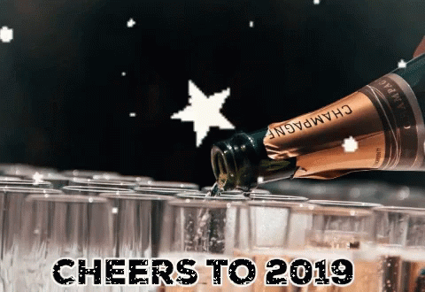 A Bottle Of Champagne Is Being Poured Into Glasses With The Words Cheers To 2019 GIF