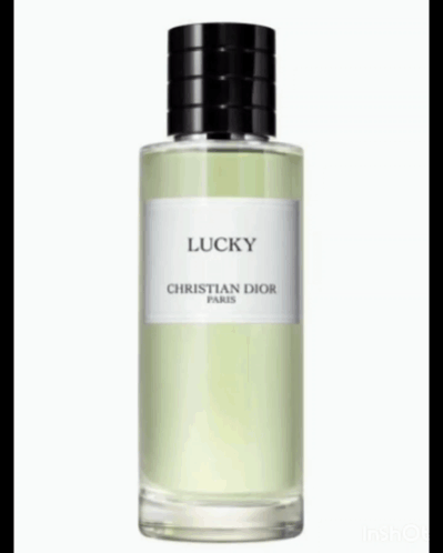 A Bottle Of Christian Dior Lucky Perfume Is Surrounded By Lily Of The Valley Flowers GIF