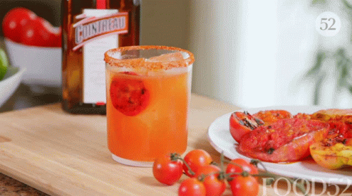 A Bottle Of Cointreau Sits Next To A Drink In A Glass GIF