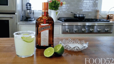 A Bottle Of Cointreau Sits On A Counter Next To A Margarita GIF
