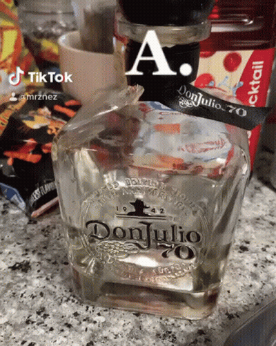 A Bottle Of Don Julio 70 Is Sitting On A Counter GIF