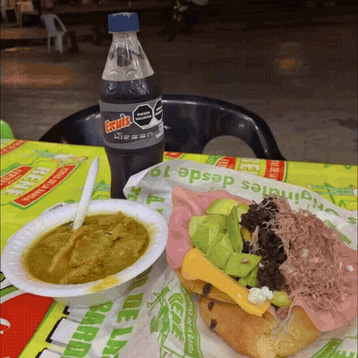 A Bottle Of Excels Sits Next To A Plate Of Food GIF