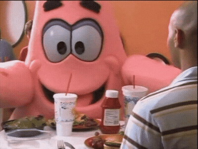 A Bottle Of Ketchup Sits On A Table Next To A Man In A Blue Shirt GIF