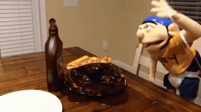A Bottle Of Ketchup Sits On A Table Next To A Puppet With The Letter Y On His Shirt GIF