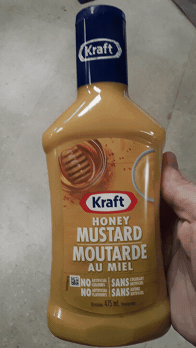 A Bottle Of Kraft Honey Mustard Is Being Held In Someone 'S Hand GIF