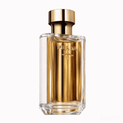 A Bottle Of La Femme Prada Perfume Sits Next To Its Box GIF