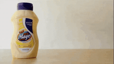 A Bottle Of Mayonnaise Is Being Poured Into Another Bottle GIF