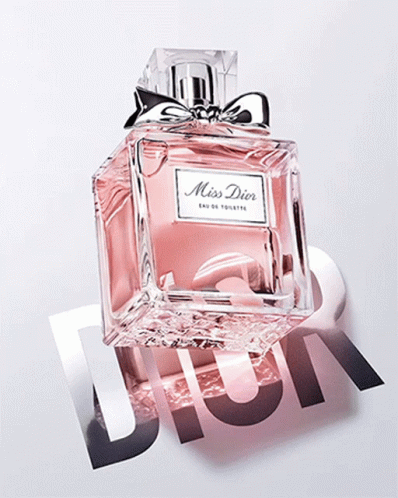 A Bottle Of Miss Dior Eau De Toilette Sits On A Dior Logo GIF