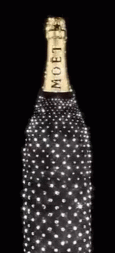 A Bottle Of Moet Champagne Is Decorated With Diamonds On A Black Background GIF