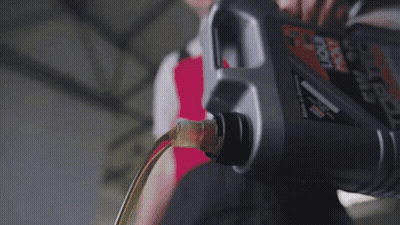 A Bottle Of Oil Is Being Poured Into A Motor GIF