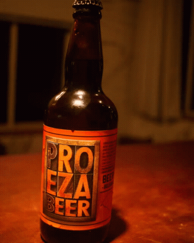 A Bottle Of Pro Ezza Beer Sits On A Table GIF