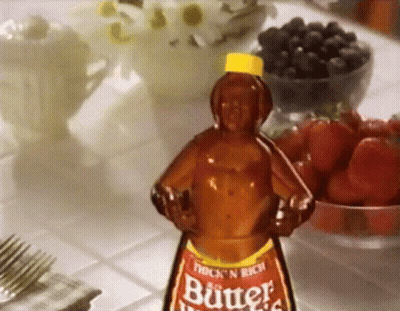 A Bottle Of Thick N Rich Butter Sits On A Table Next To Fruit GIF